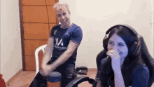 a man and a woman wearing headphones are sitting in a room .