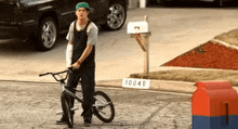 a man is standing next to a bicycle with a sign that says 10048