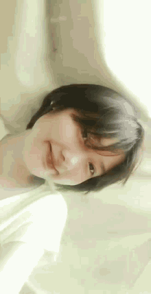 a young girl with short hair is smiling and looking at the camera