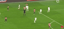 a soccer game is being played on a field with advertisements for trainline mg motor and snickers