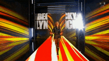 a woman in a leather jacket is walking down a red carpet with the name becklyn on it