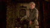 a man in a robe is standing in front of a sign that says but now i see it 's just