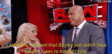 a man in a suit and tie is talking to a woman in a dress .