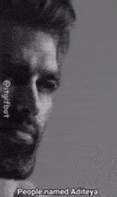 a black and white photo of a man with a beard and a caption that says `` people named aditaya '' .