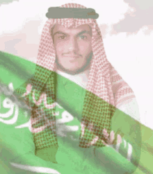 a man in a keffiyeh holding a green flag