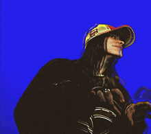 a man wearing a hat that says supreme on it