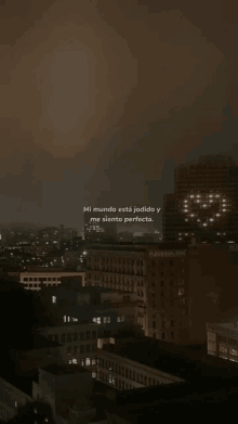 a city at night with a quote in spanish