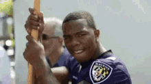 Ray Rice Peace Sign Finger GIF - Ray Rice Peace Sign Finger Holding Onto A Stick GIFs