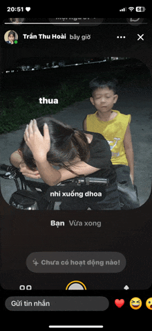 a phone screen shows a girl covering her face and a boy standing behind her