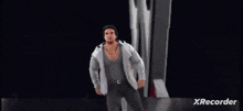 a man in a suit is dancing in front of a wwe logo .