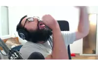a man with a beard wearing headphones and a white shirt