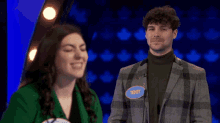 a man and a woman are standing next to each other and the man has a name tag that says teddy