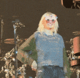 a woman wearing sunglasses with flowers on them is smiling
