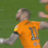 a soccer player kneeling down with maddison on the back of his shirt