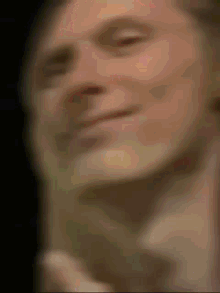 a blurry picture of a man 's face with a black background