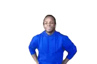 a man in a blue hoodie is holding his hand to his head .
