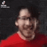 a blurred image of a person 's face with a tiktok watermark
