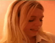 a close up of a woman 's face with her mouth open .
