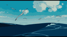 a flock of seagulls are flying over a blue ocean