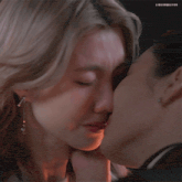 a close up of two people kissing with the words lingermgifs below them