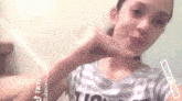 a young girl is taking a selfie with her phone .