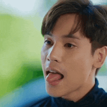 a close up of a man 's face with his tongue hanging out