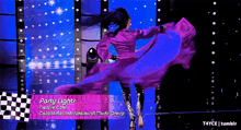 a woman in a purple dress is dancing in front of a checkered flag that says party lights on it