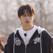 a young man wearing a black hoodie that says sv nana bnb on the front