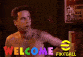 a shirtless man is standing in front of a sign that says " welcome football "