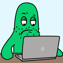 a cartoon drawing of a green monster sitting in front of a laptop