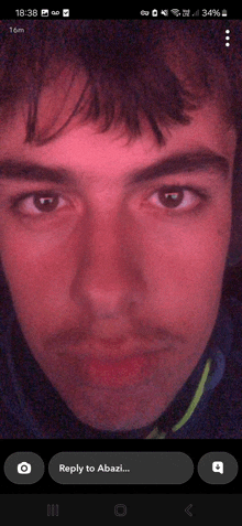 a close up of a man 's face with a reply to abazi button