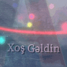 a sign that says xos geldin on it with a bridge in the background