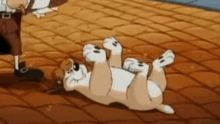 a cartoon dog is rolling on its back on a brick floor .
