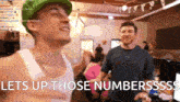 a man in a green hat says lets up those numberssss