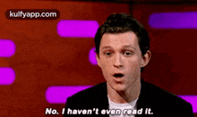a man is talking on a stage and saying `` no , i haven 't even read it '' .