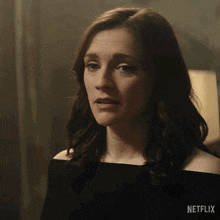 a close up of a woman 's face with a netflix logo behind her