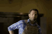 a man in a plaid shirt is carrying a backpack that says 5.11