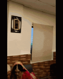 a woman in a red dress stands in a room with a clock on the wall