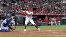 a baseball player with the number 6 on his jersey swings at a pitch