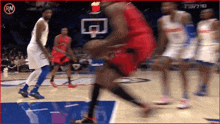 a blurry picture of a basketball game with the letters rn on the bottom right