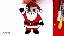 a drawing of santa claus is being drawn on a piece of paper