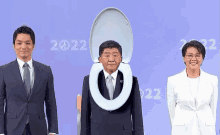 a man in a suit has a toilet seat in front of his head .