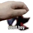a pixelated image of a hand holding a piece of paper with the words `` good boy '' written on it .