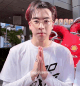 a man wearing glasses and a white shirt with the word say cheese on it