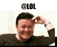 a man is making a funny face with his hand on his head .