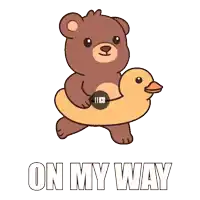 a brown teddy bear is holding a yellow rubber duck and the words on my way are below it