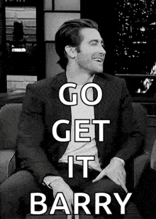 a black and white photo of a man in a suit sitting in a chair with the words go get it barry .