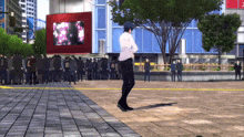 a man in a white shirt stands in front of a crowd in front of a building that says tokyo