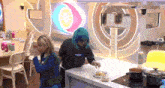 a woman wearing a sweatshirt that says " will " is cooking in a kitchen