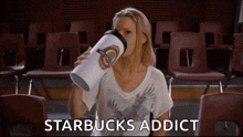 a woman drinking from a starbucks cup with the words starbucks addict below her